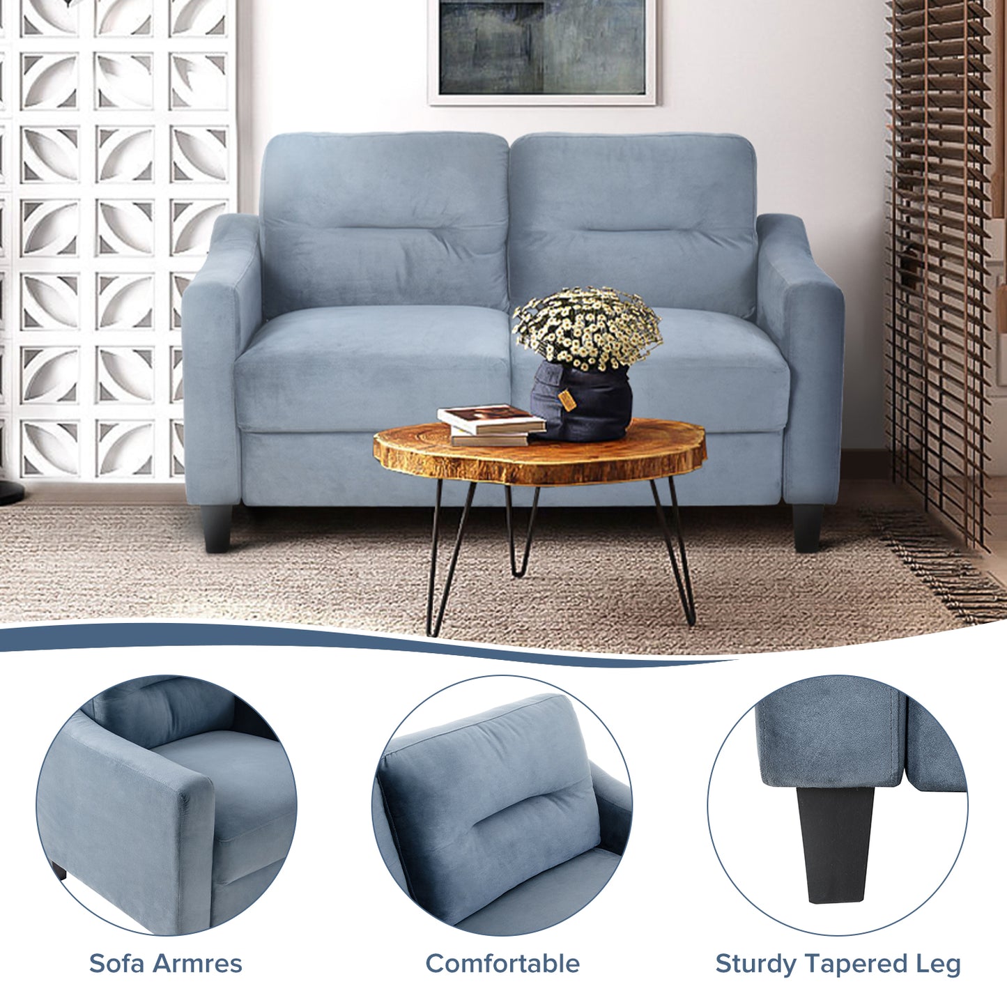 Light blue velvet sofa with plush cushions and wooden coffee table