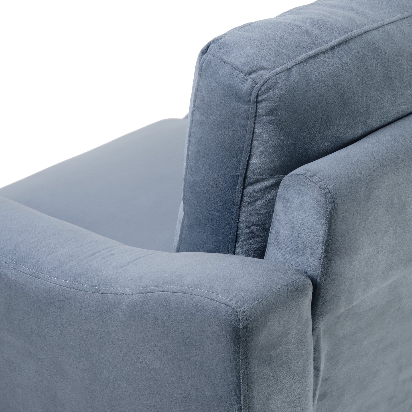 Closeup of a plush blue velvet armchair armrest with detailed stitching