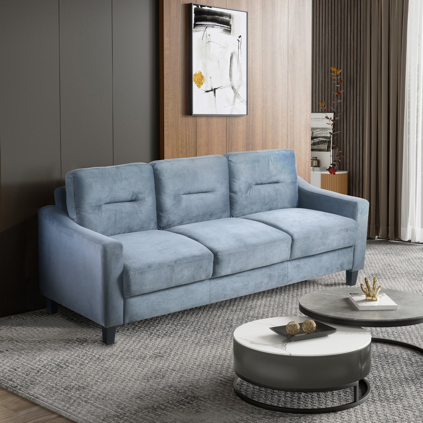 Light blue velvet threeseater sofa with plush cushions perfect for a modern living room