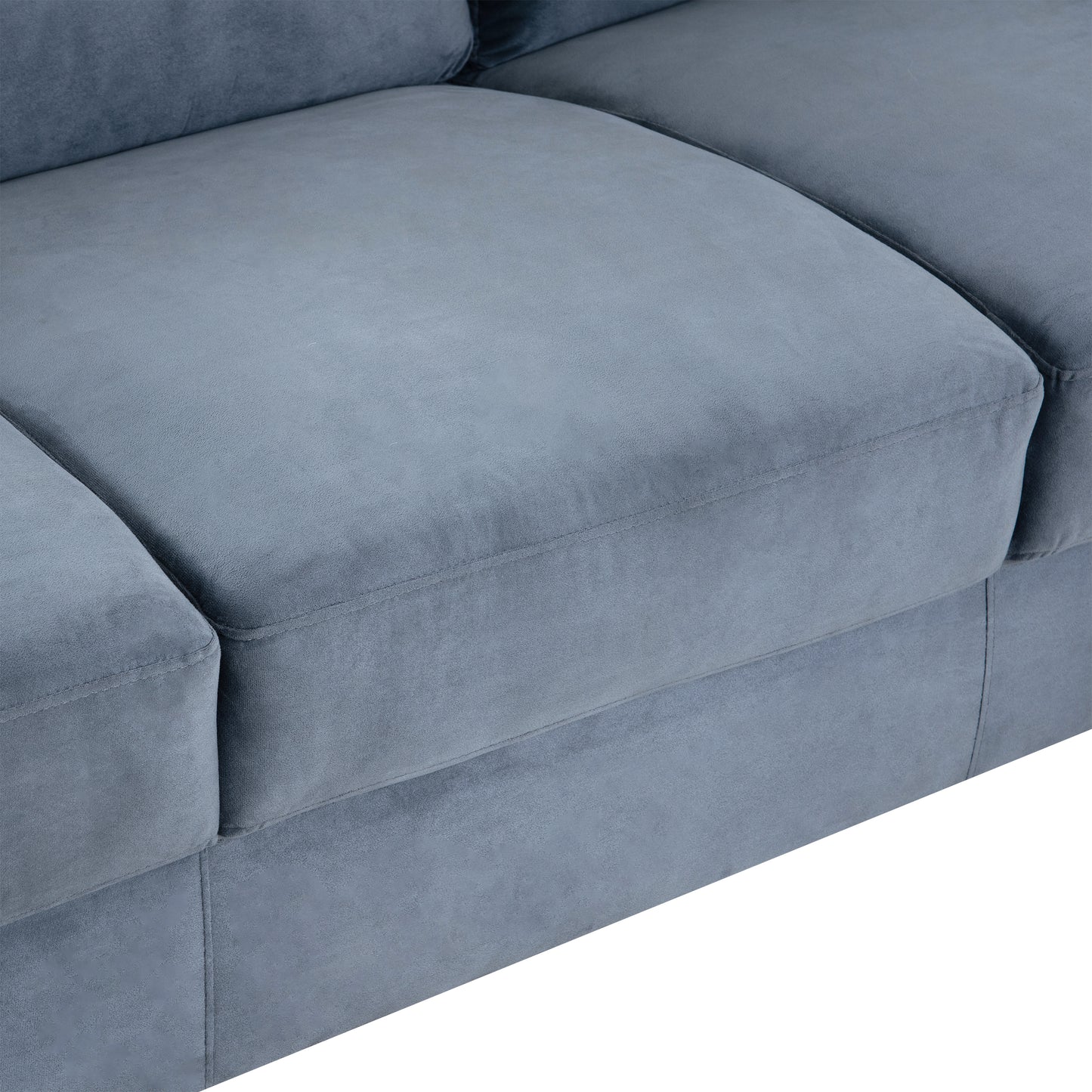Closeup of plush blue velvet sofa cushions with detailed stitching