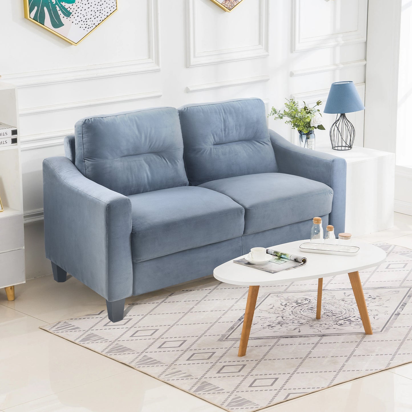 Plush blue velvet loveseat with tufted cushions perfect for a cozy living room