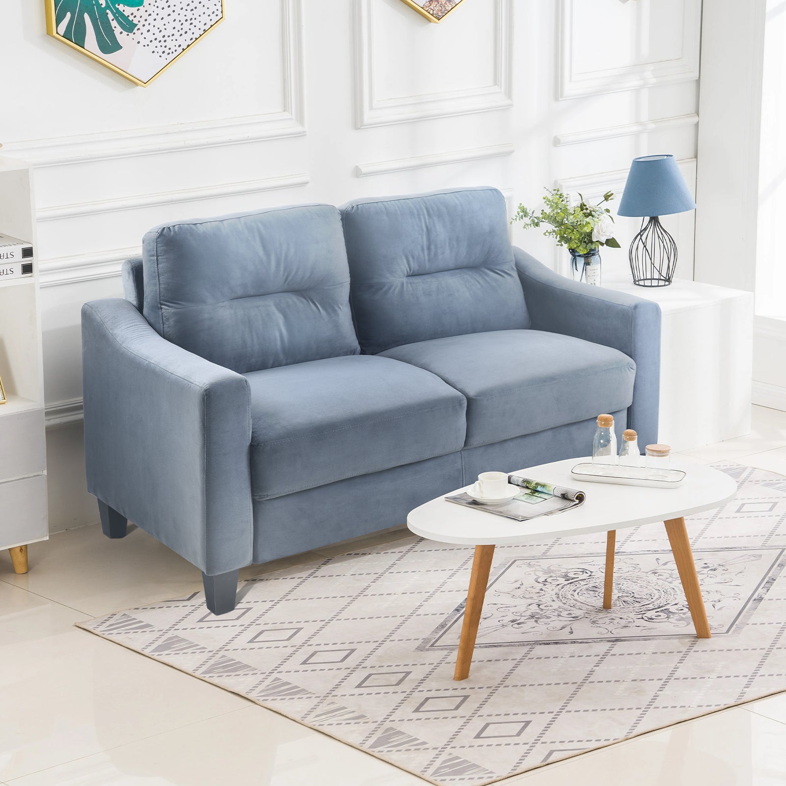Plush blue velvet loveseat with tufted cushions perfect for a cozy living room