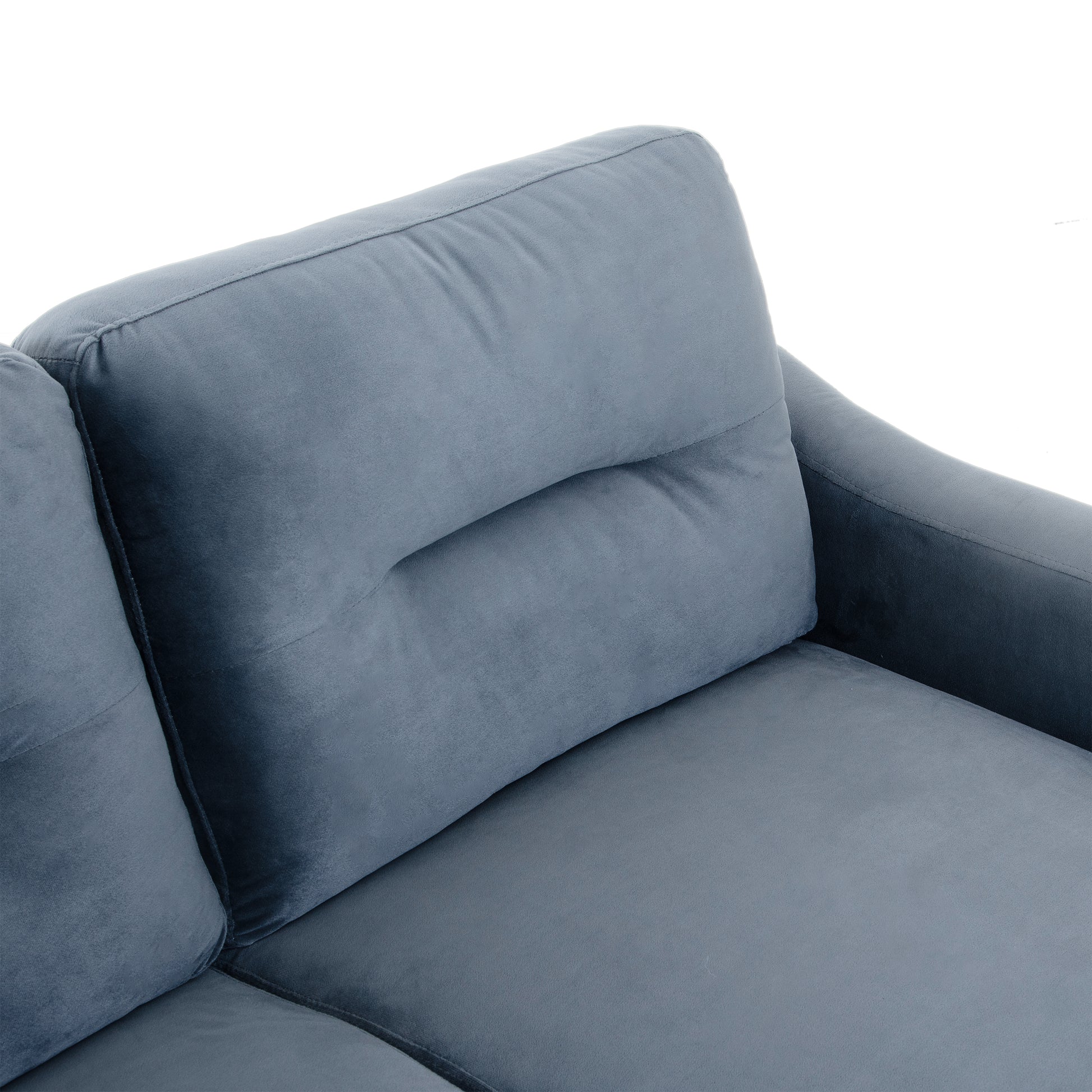 Closeup of a plush grey velvet sofa cushion with tufted detail