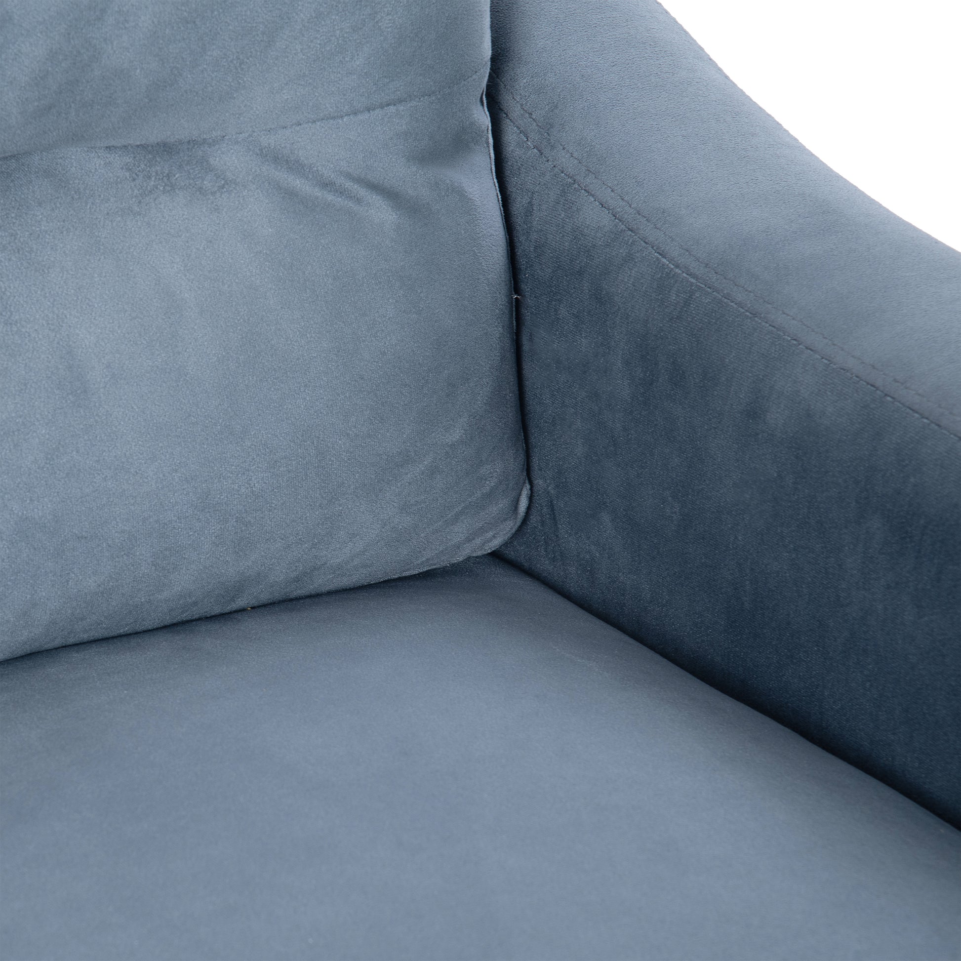 Closeup of a plush slate grey velvet sofa cushion with visible stitching