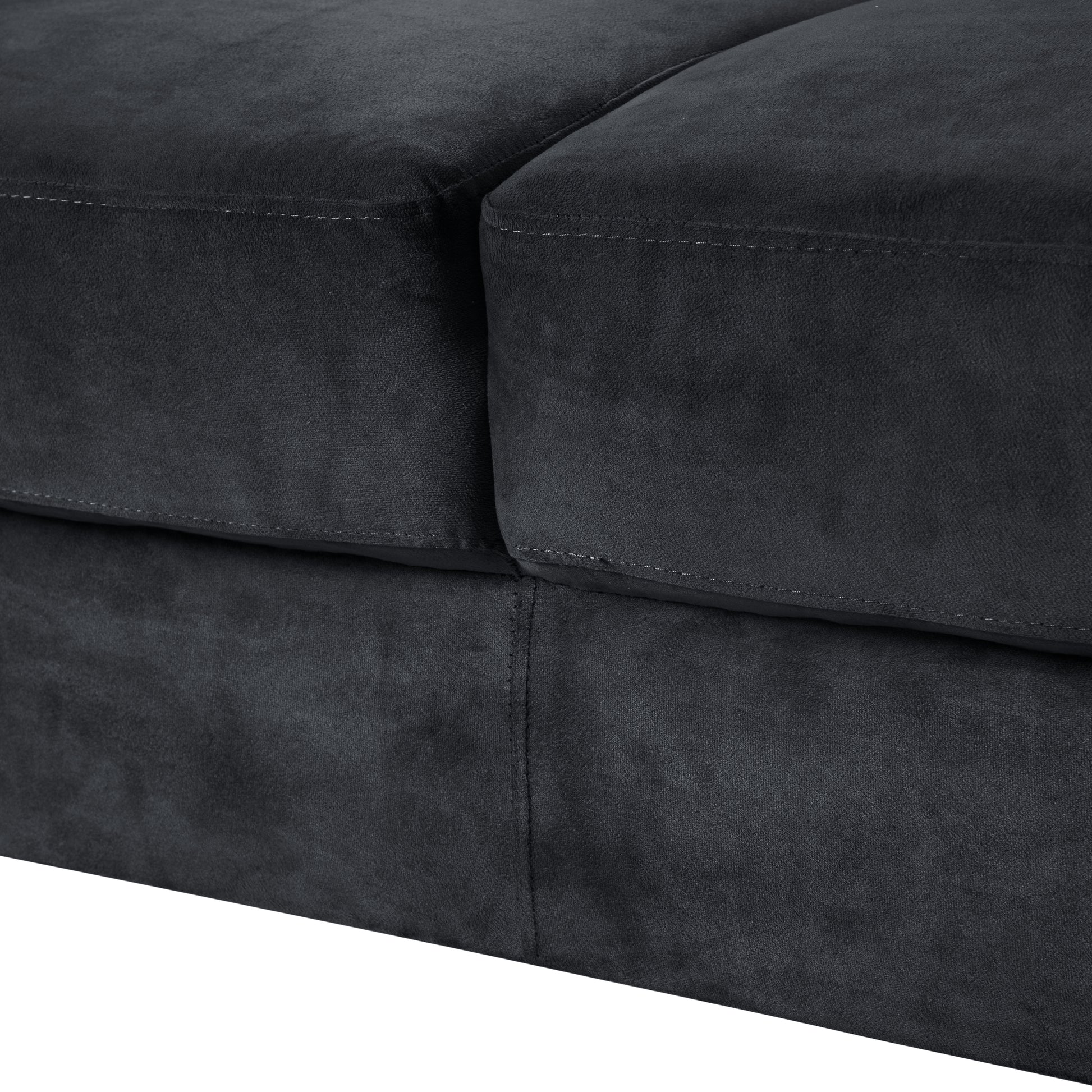 Closeup of charcoal grey velvet sofa texture with visible stitching