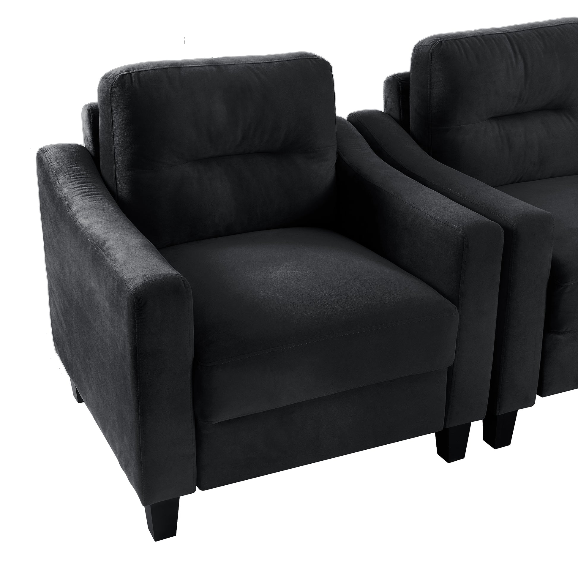 Plush black velvet armchair with tufted back and square armrests perfect for modern living rooms