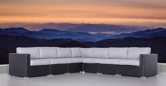 Dark grey wicker sectional patio sofa with light grey cushions