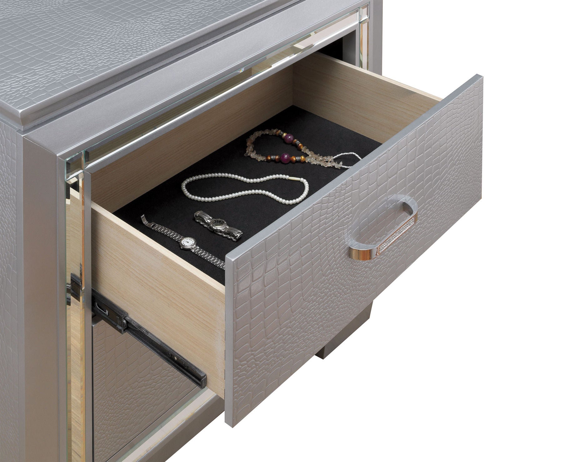 Silver crocodile textured dresser with open drawer revealing jewelry