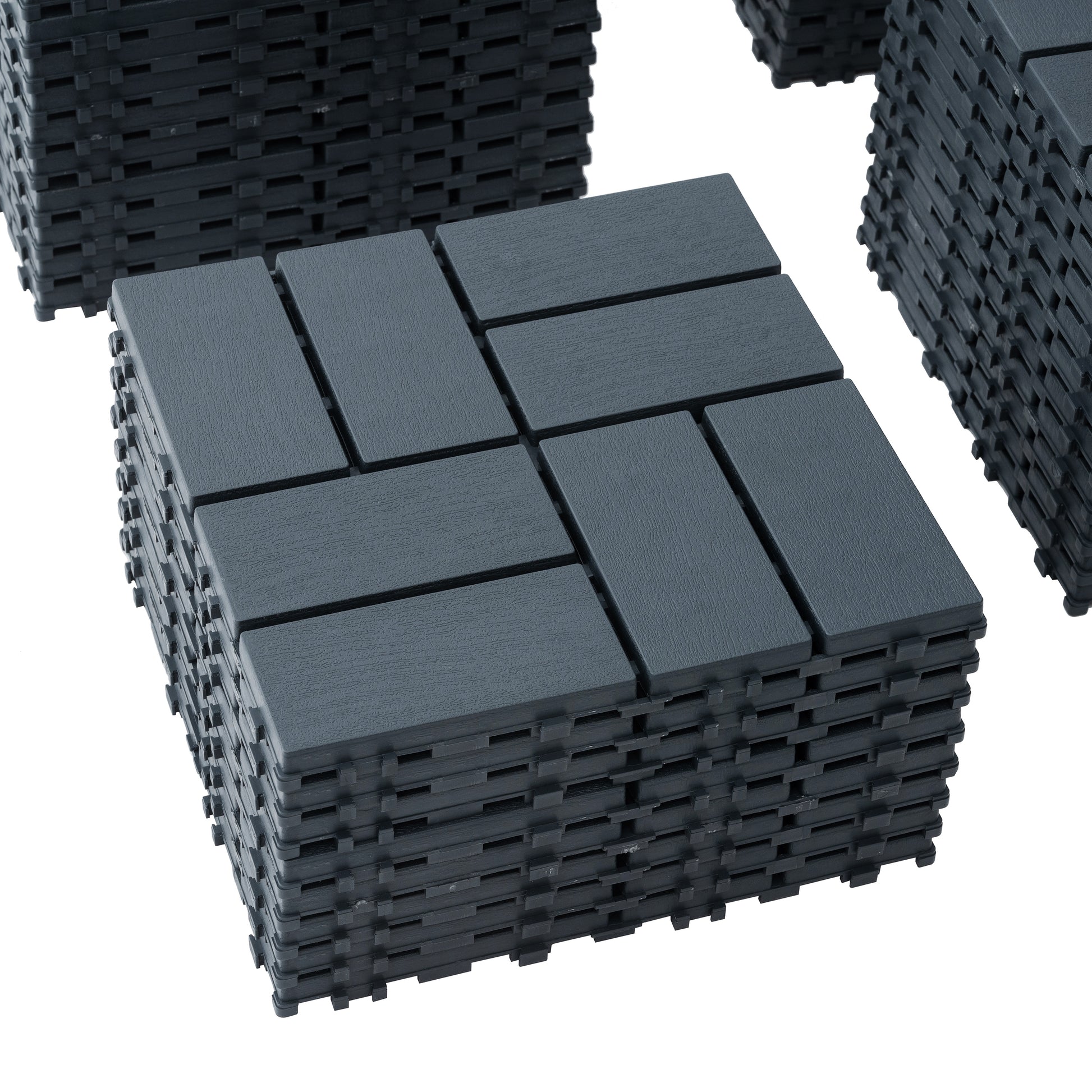 Stack of dark grey interlocking deck tiles with a wood grain texture