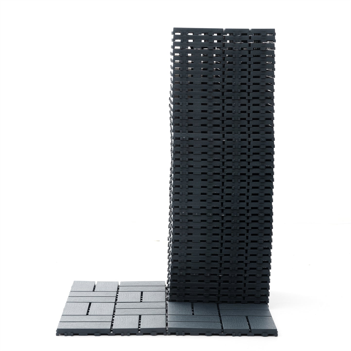 Stack of dark gray interlocking deck tiles on a white background