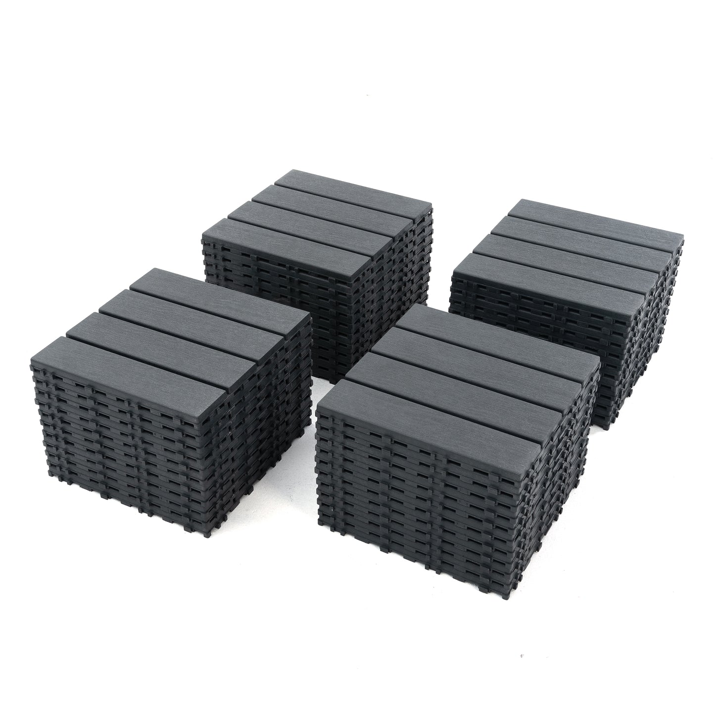 Four stacks of dark gray interlocking composite deck tiles designed for easy DIY patio installation
