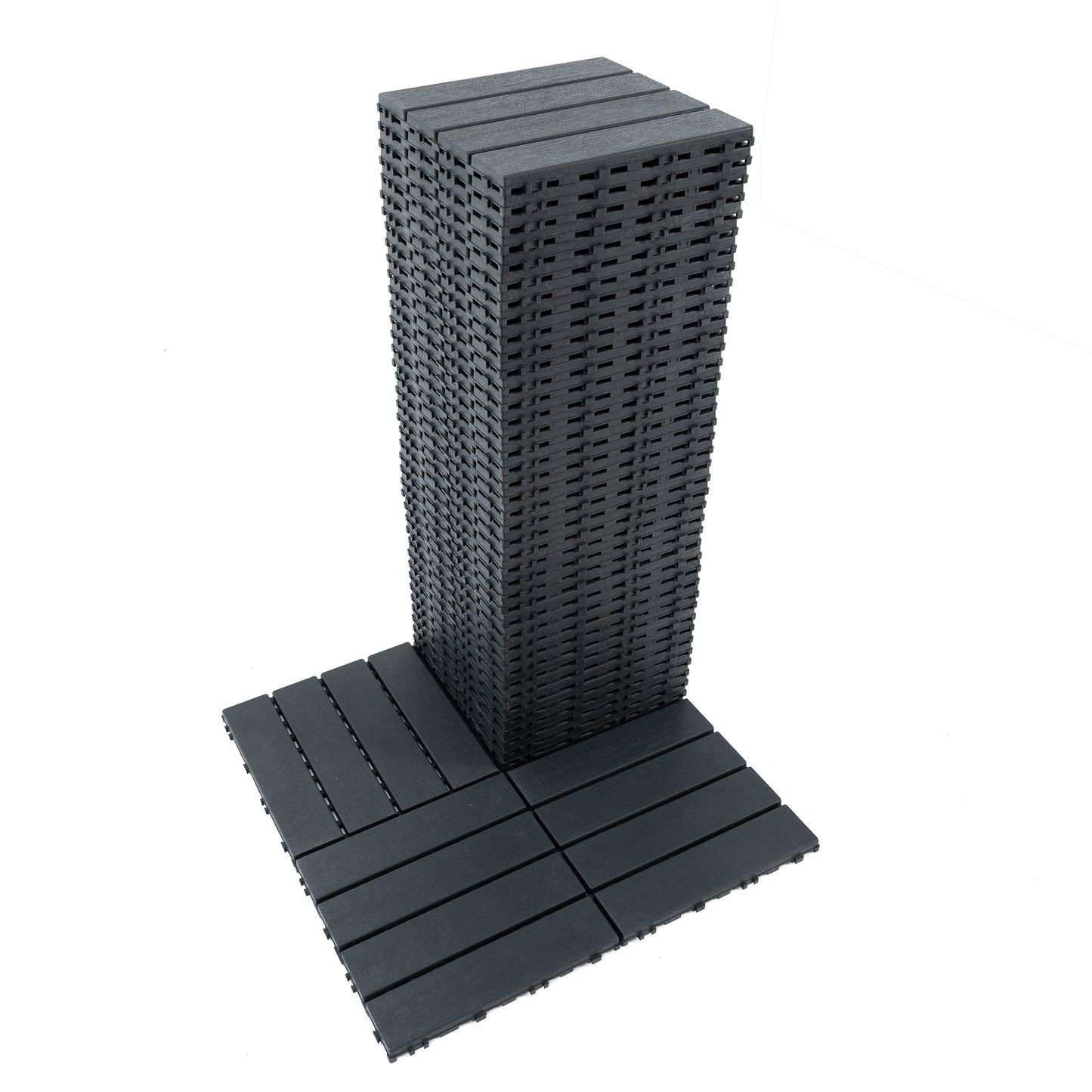 Stack of dark grey interlocking deck tiles showing their slatted surface and underside connectors
