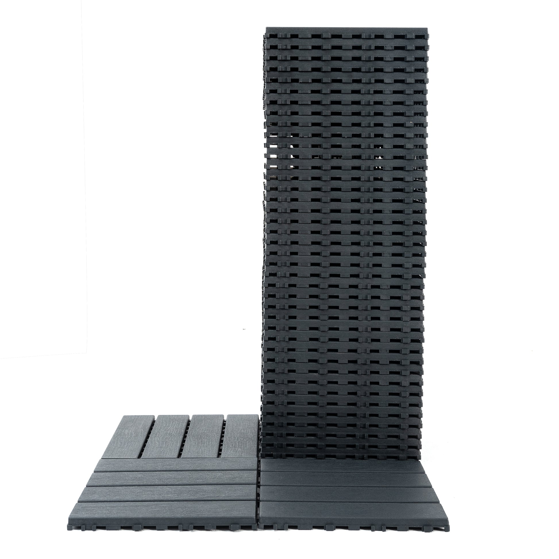 Stack of dark grey composite decking tiles designed for easy interlocking patio installation