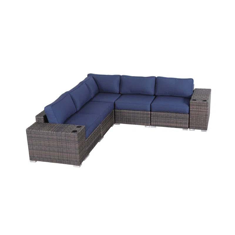 Dark brown wicker sectional outdoor sofa with navy blue cushions and builtin cup holders