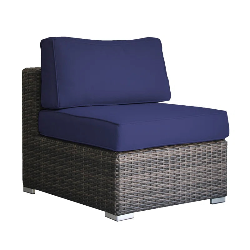 Deep navy blue cushions on a woven rattan sectional chair with silver feet