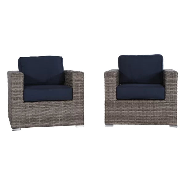 Two gray wicker armchairs with navy blue cushions