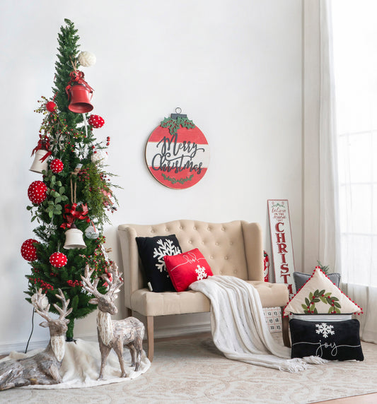 Tall slender artificial Christmas tree with red and white ornaments and bells