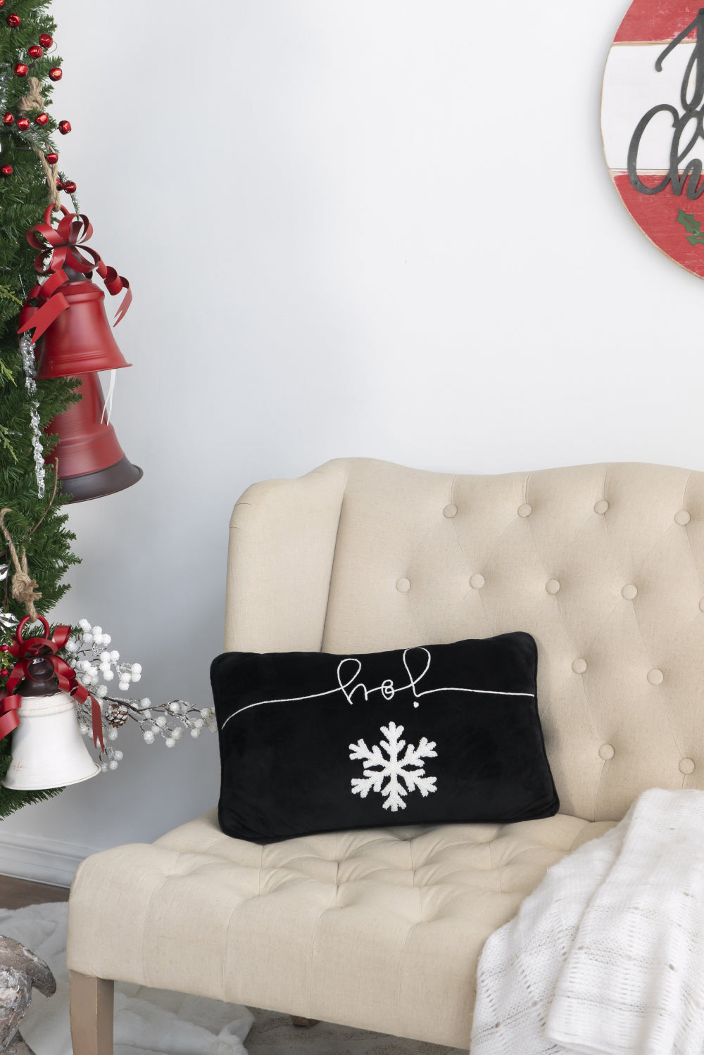 Black throw pillow with white joy text and snowflake design
