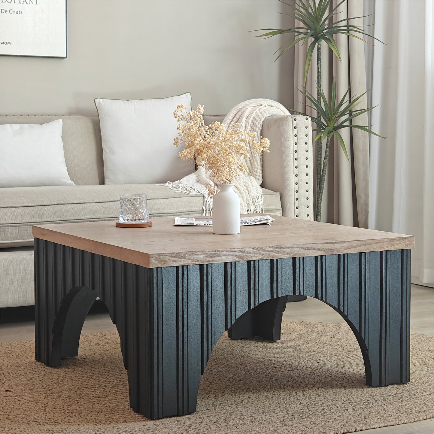 Modern square coffee table with light wood top and dark ribbed base