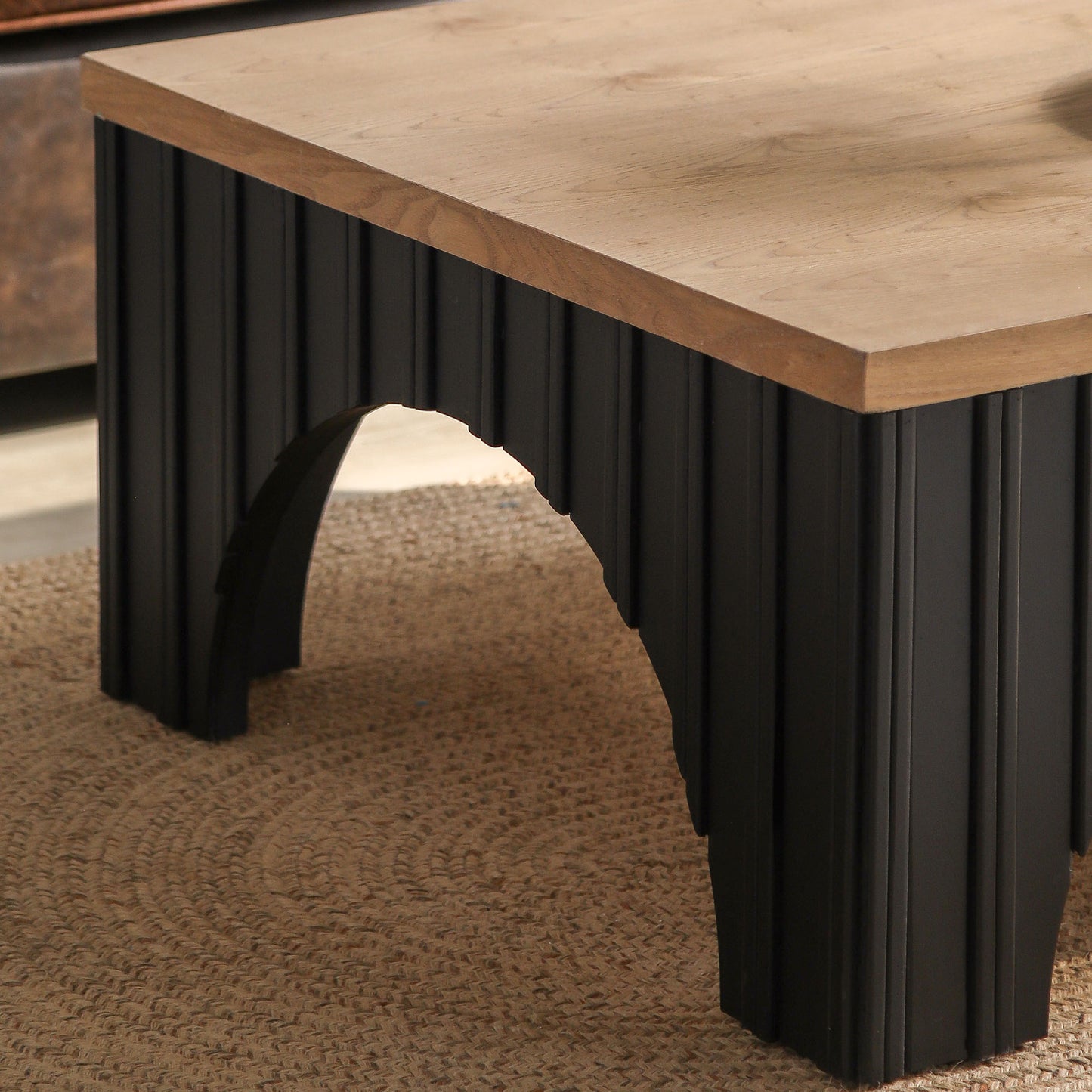 Modern coffee table with light oak wood top and fluted black base