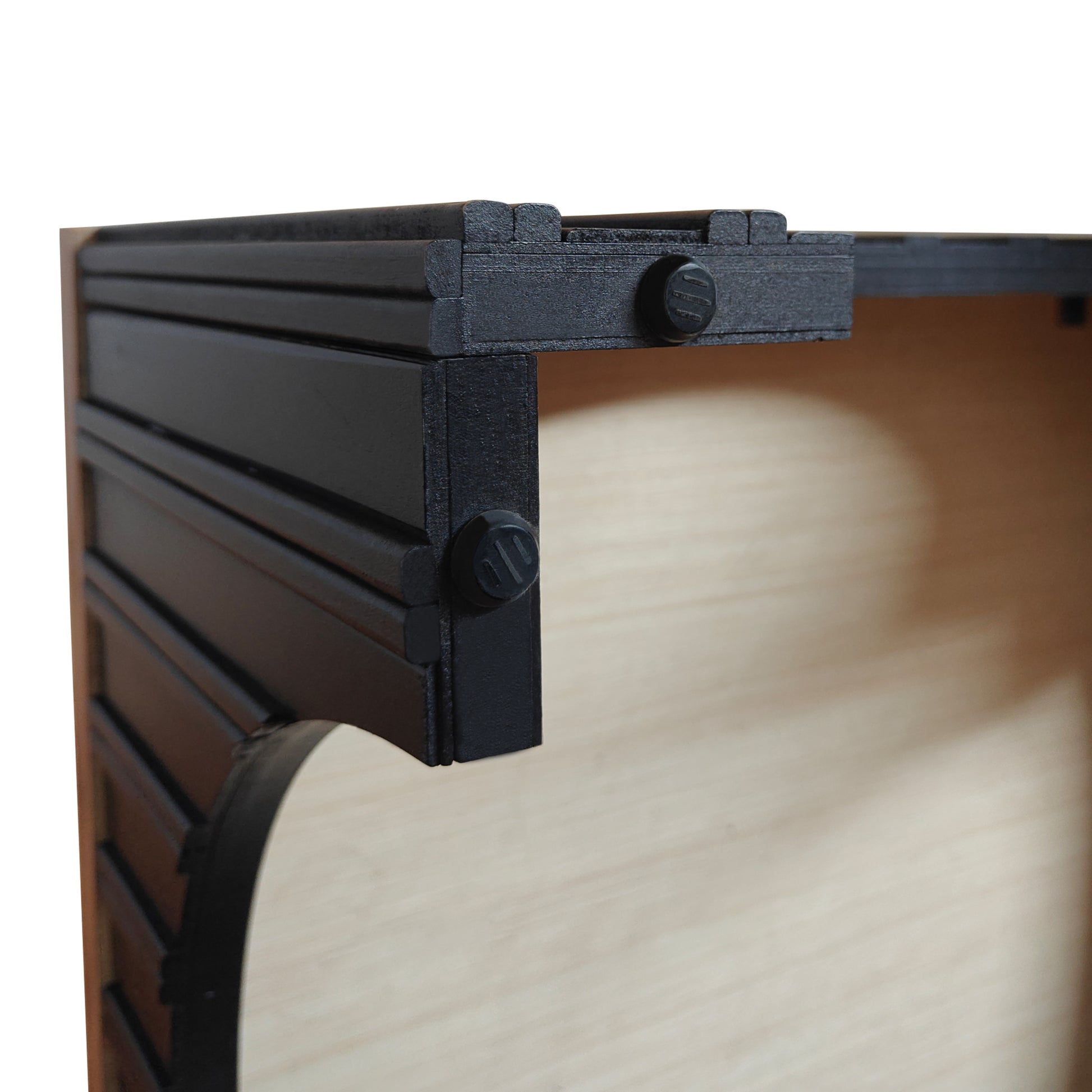 Dark wood cajon with black ornate detailing and visible screws