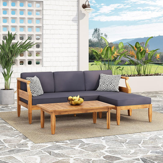 Teak wood sectional outdoor sofa with charcoal cushions and a modern coffee table