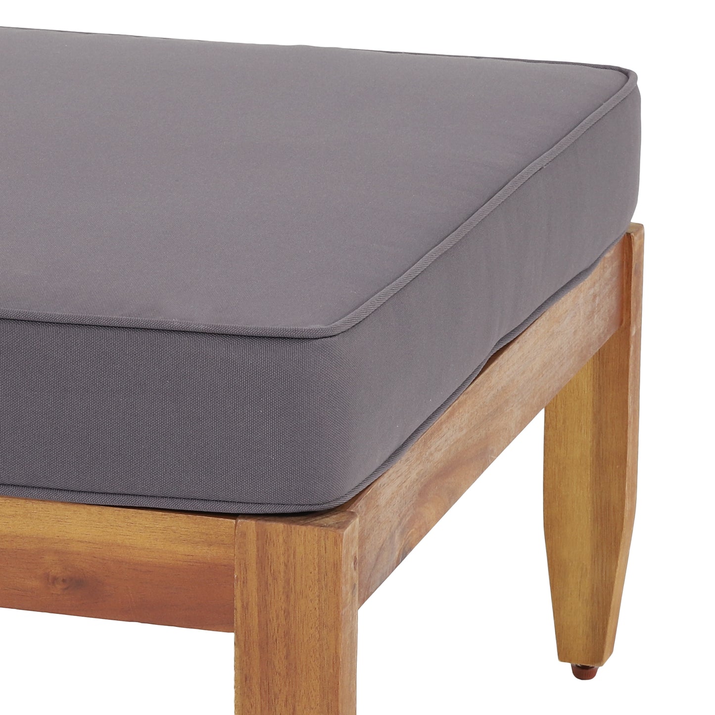 Dark grey outdoor bench cushion with piped edge on a natural wood frame