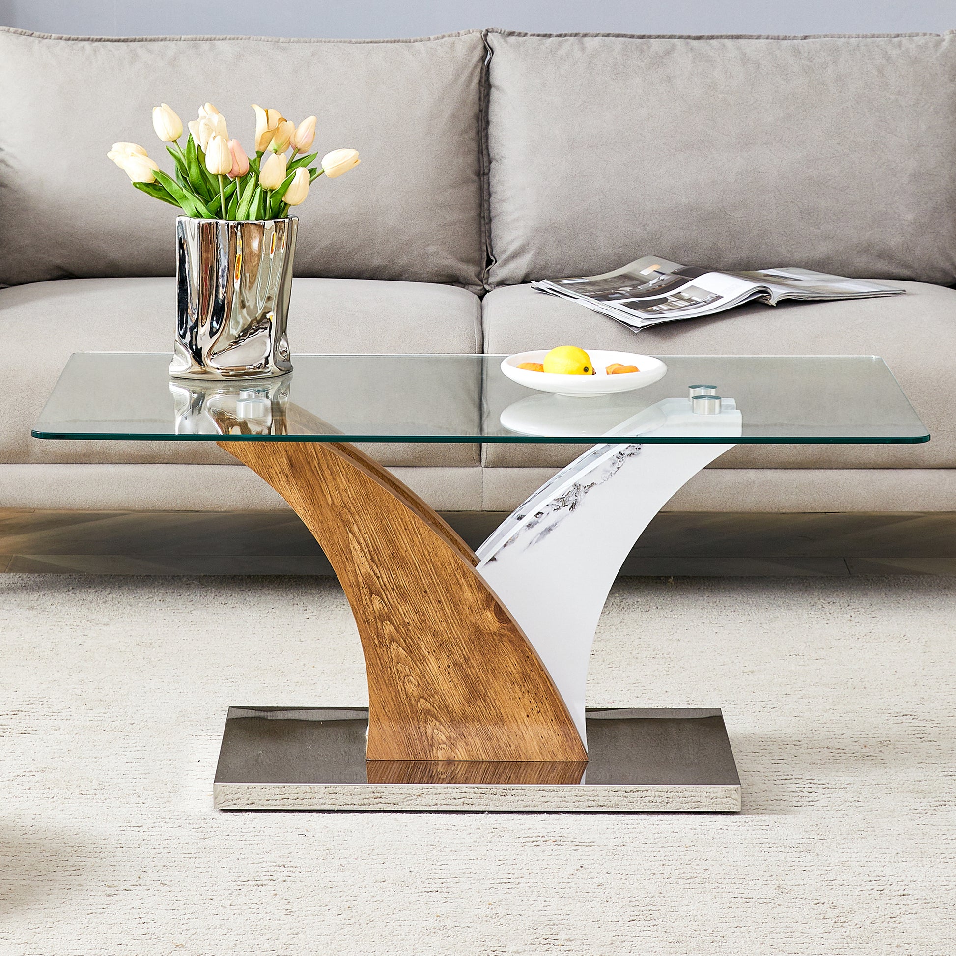 Modern glass coffee table with a wood grain and marble pedestal base