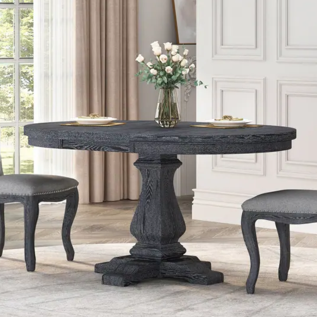 Distressed charcoal round dining table with pedestal base and two upholstered chairs