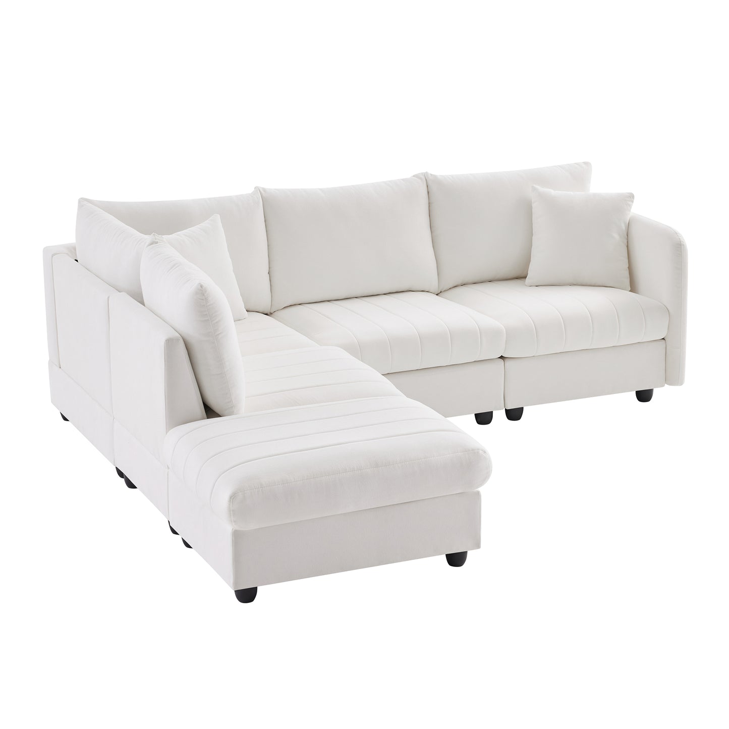 White velvet sectional sofa with tufted cushions and multiple throw pillows