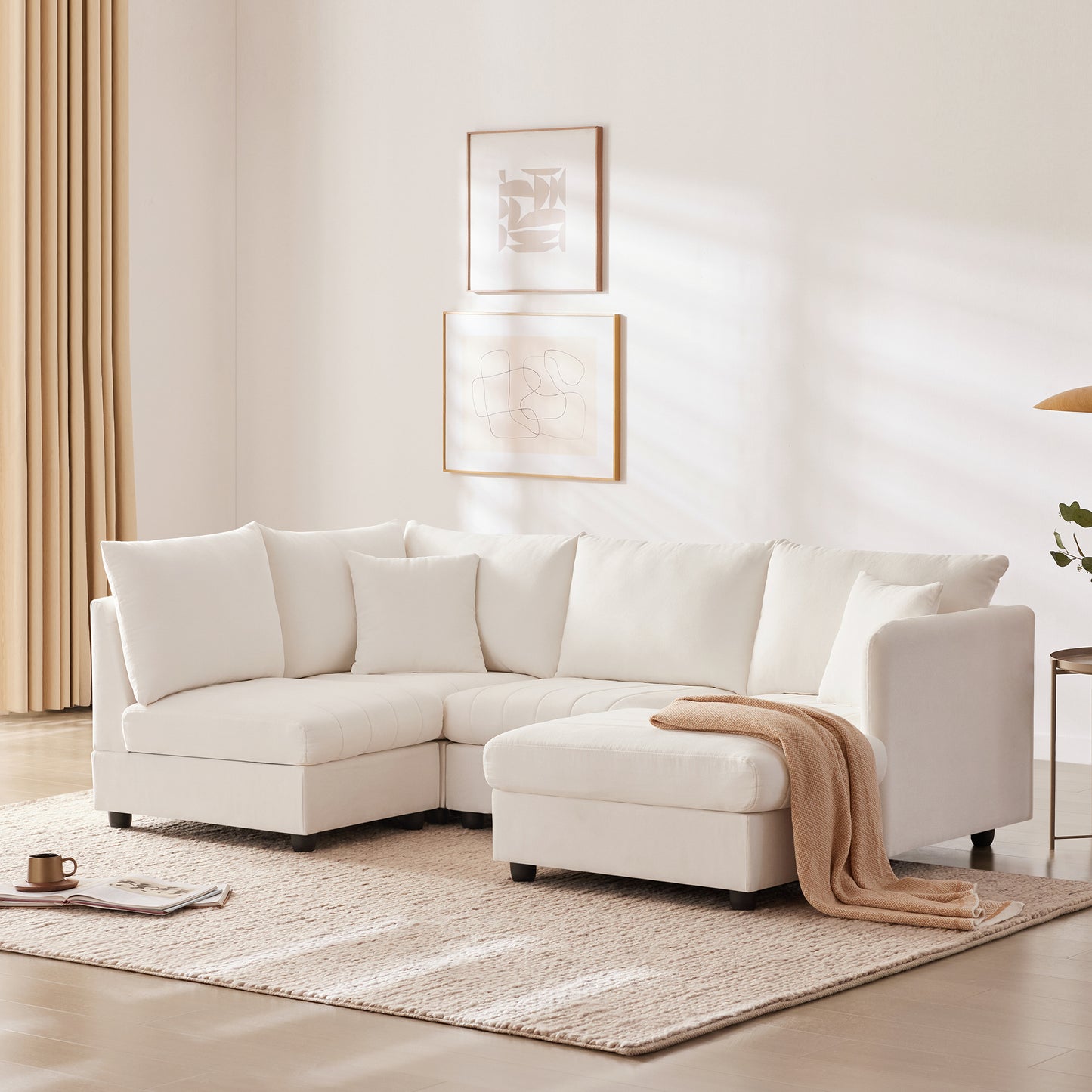 Plush white sectional sofa with chaise lounge and numerous cushions perfect for modern living rooms