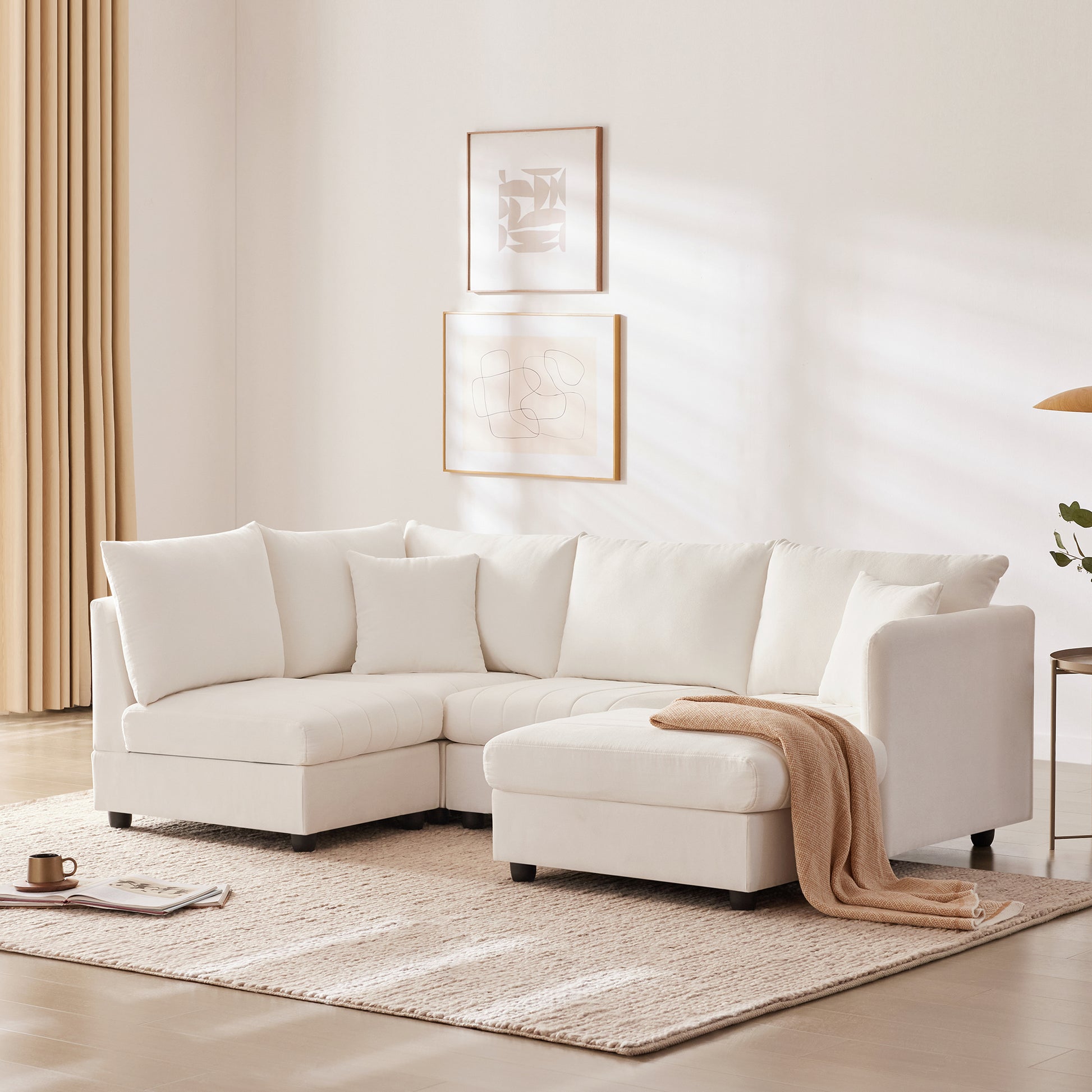 Plush white sectional sofa with chaise lounge and numerous cushions perfect for modern living rooms