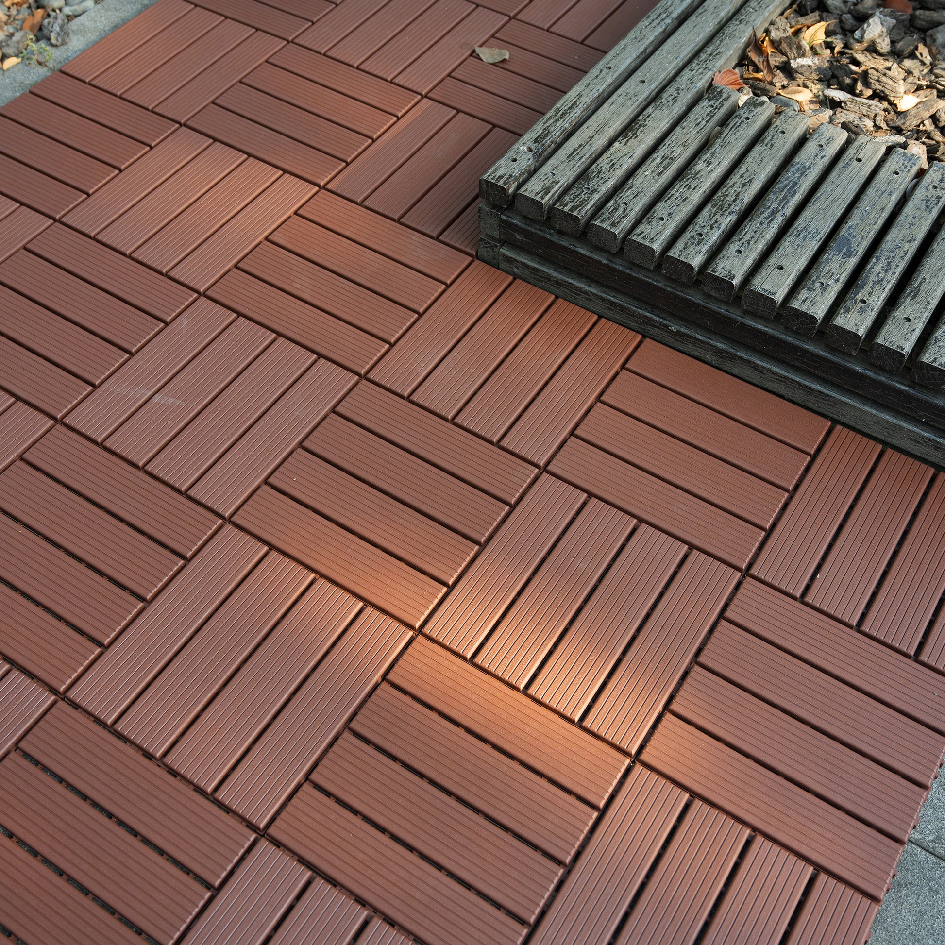 Brown composite wood deck tiles with interlocking design for outdoor patios