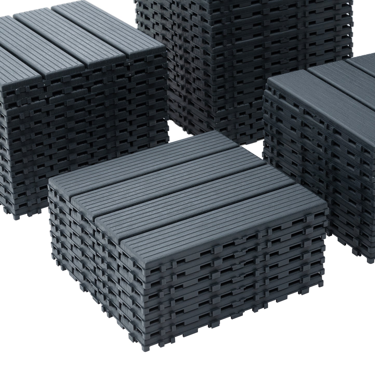 Stack of dark grey composite decking tiles with grooved texture