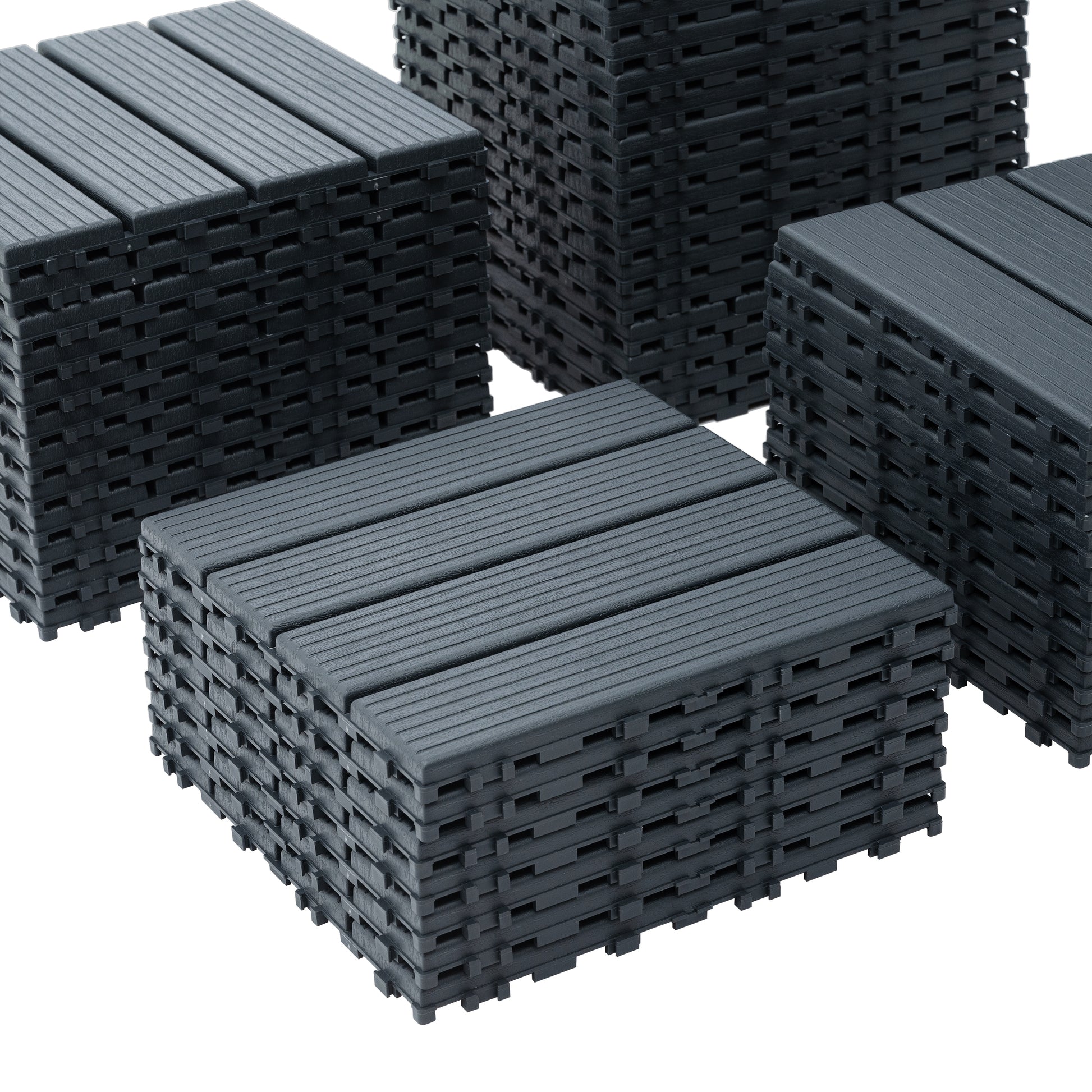 Stack of dark grey composite decking tiles with grooved texture