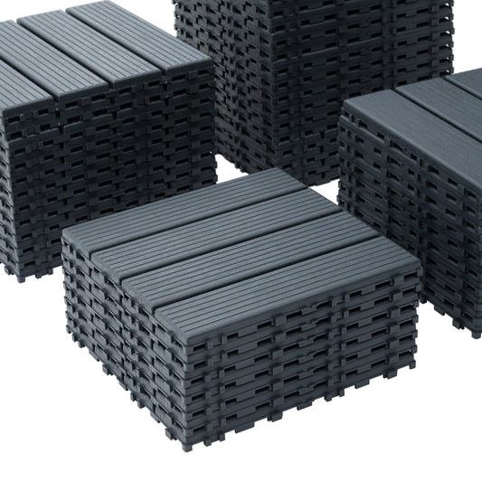 Stack of dark grey composite decking tiles with grooved texture