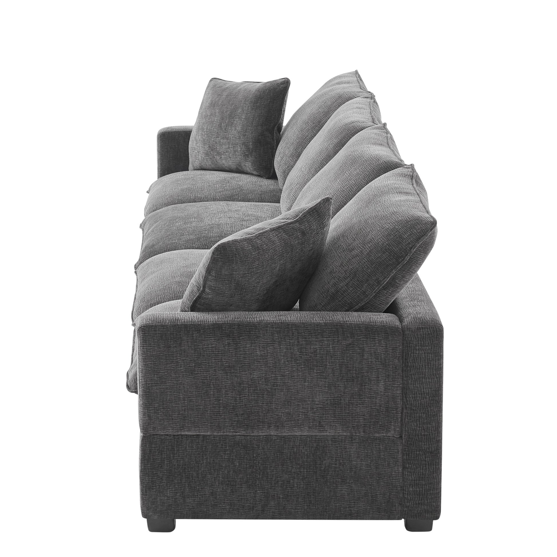 Plush charcoal grey sofa with deep channel tufted cushions and matching throw pillows