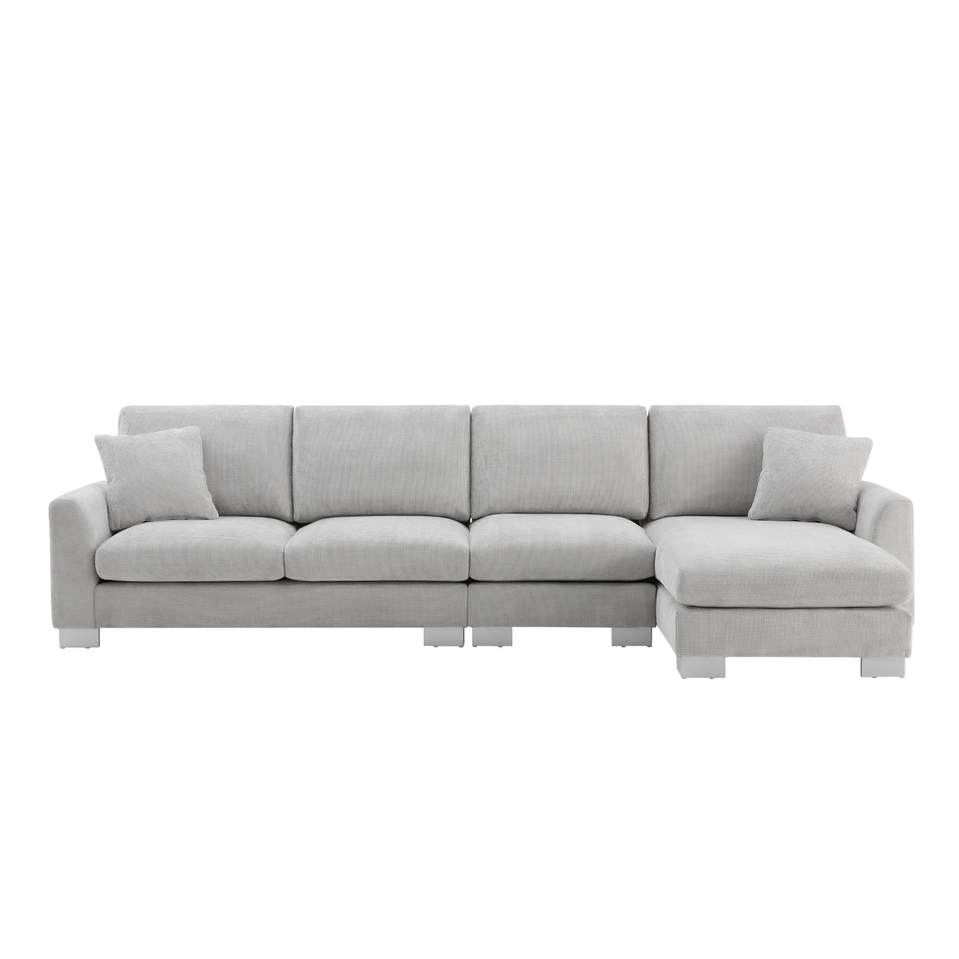 Light grey fabric sectional sofa with modern silver legs and two accent pillows for living room comfort