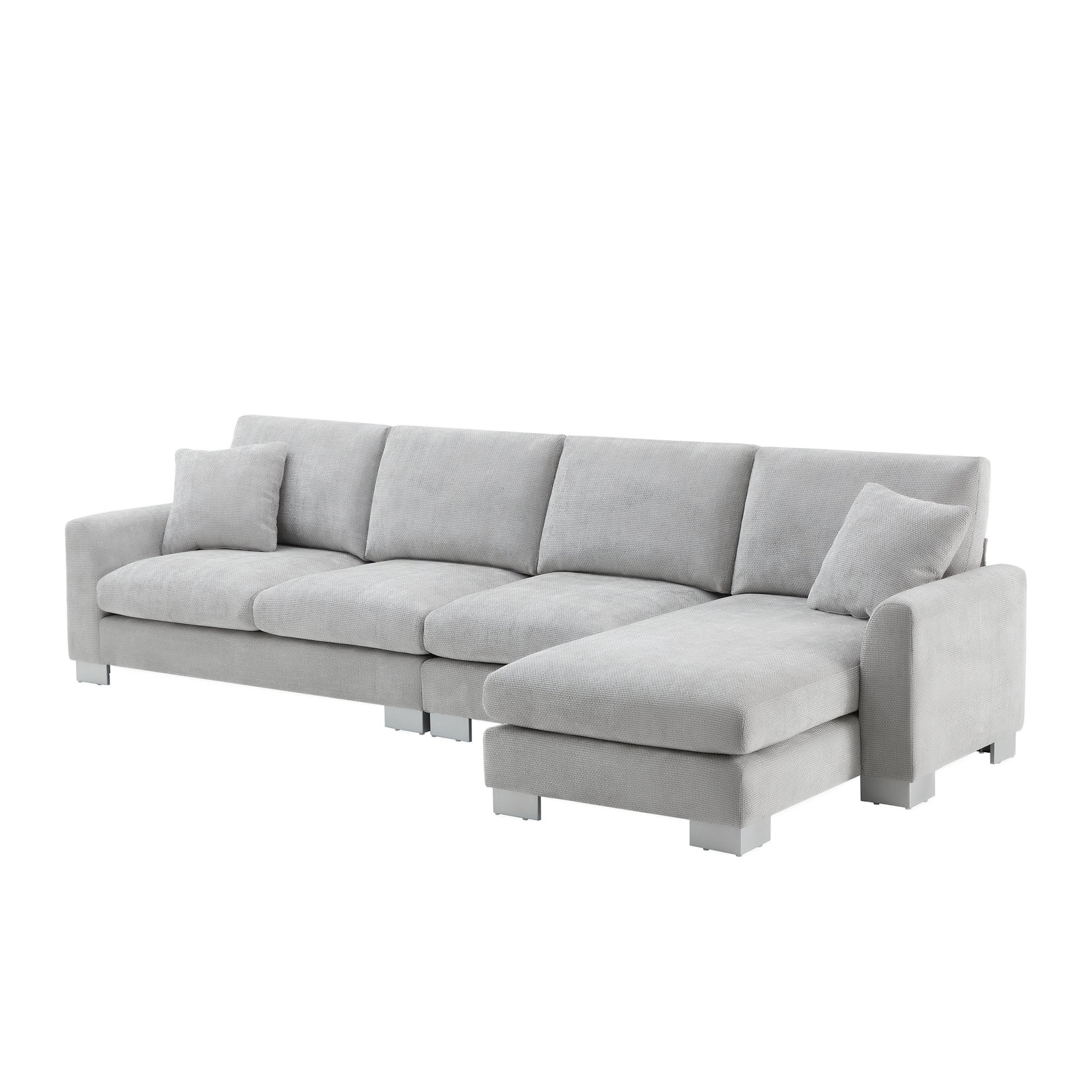 Light gray fabric sectional sofa with chrome legs and accent pillow