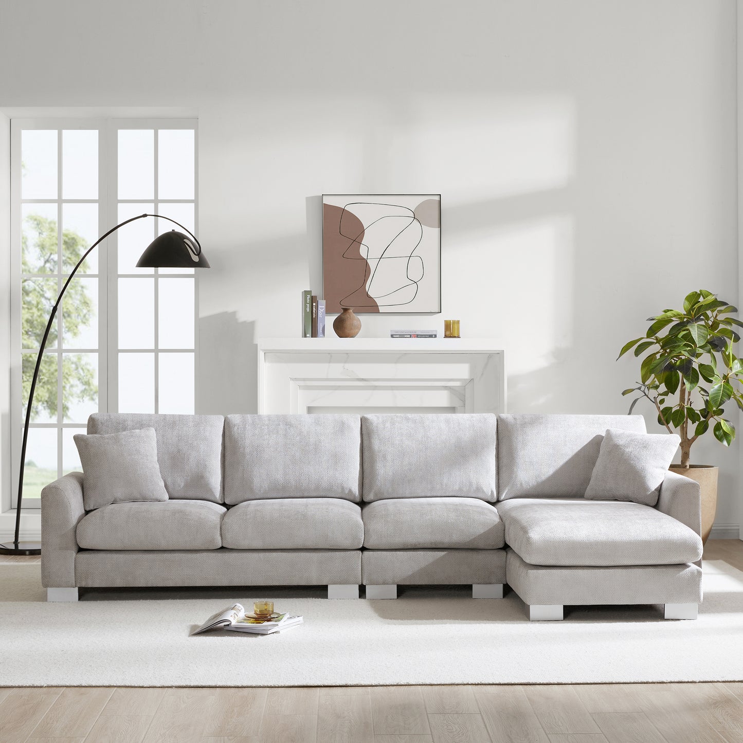 Light gray sectional sofa with plush cushions and modern white legs