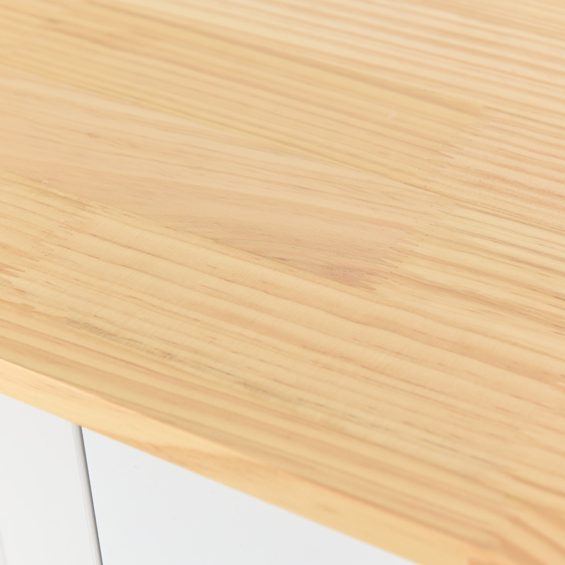 Light pine wood desktop texture with visible grain and edge detail