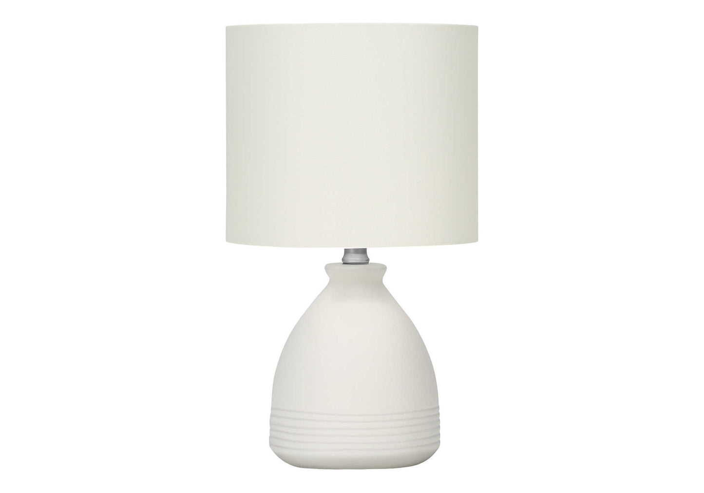 White ceramic bedside lamp with textured base and cream fabric shade