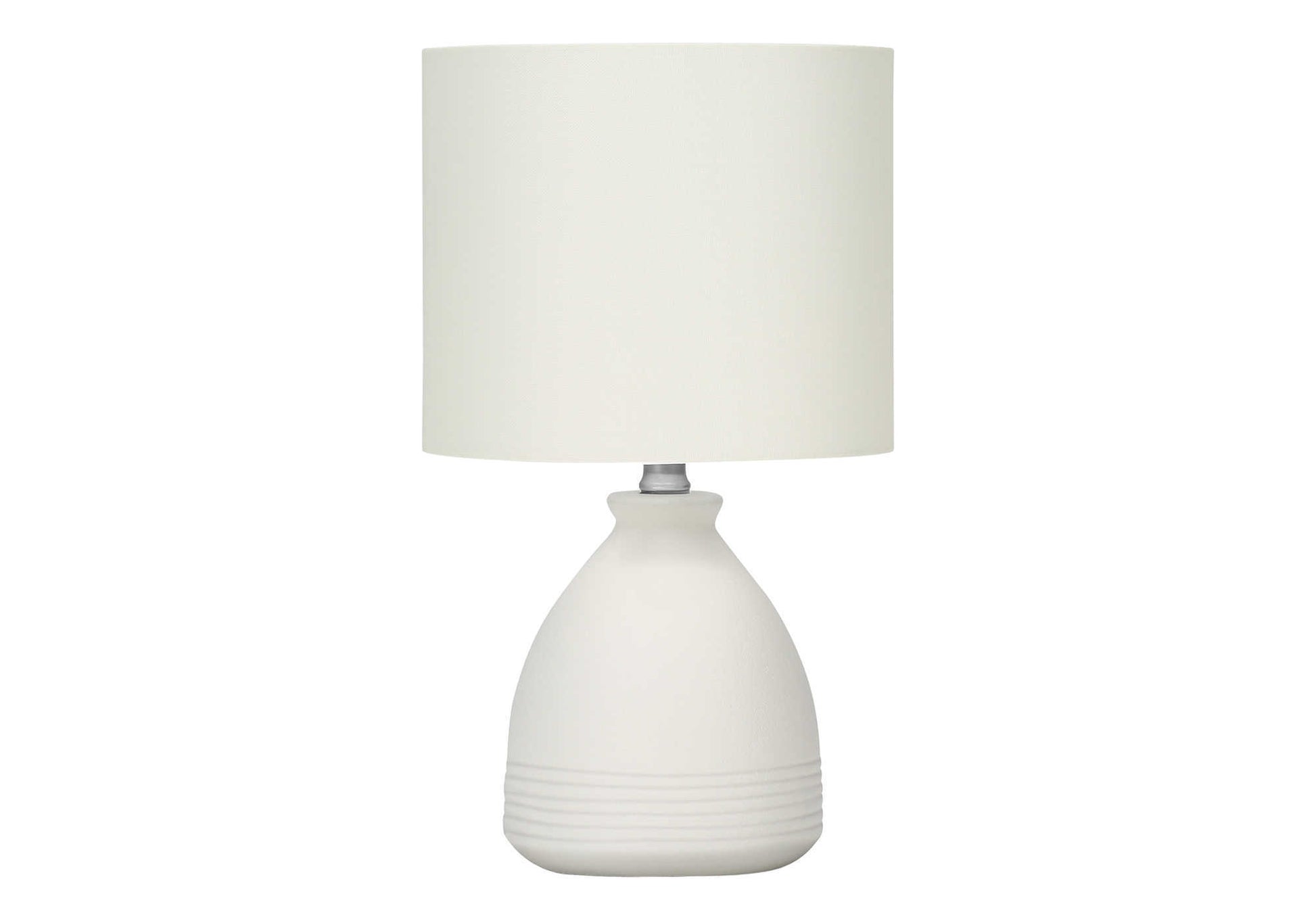 White ceramic bedside lamp with textured base and cream fabric shade