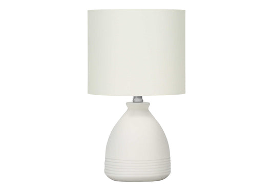 White ceramic bedside lamp with textured base and cream fabric shade