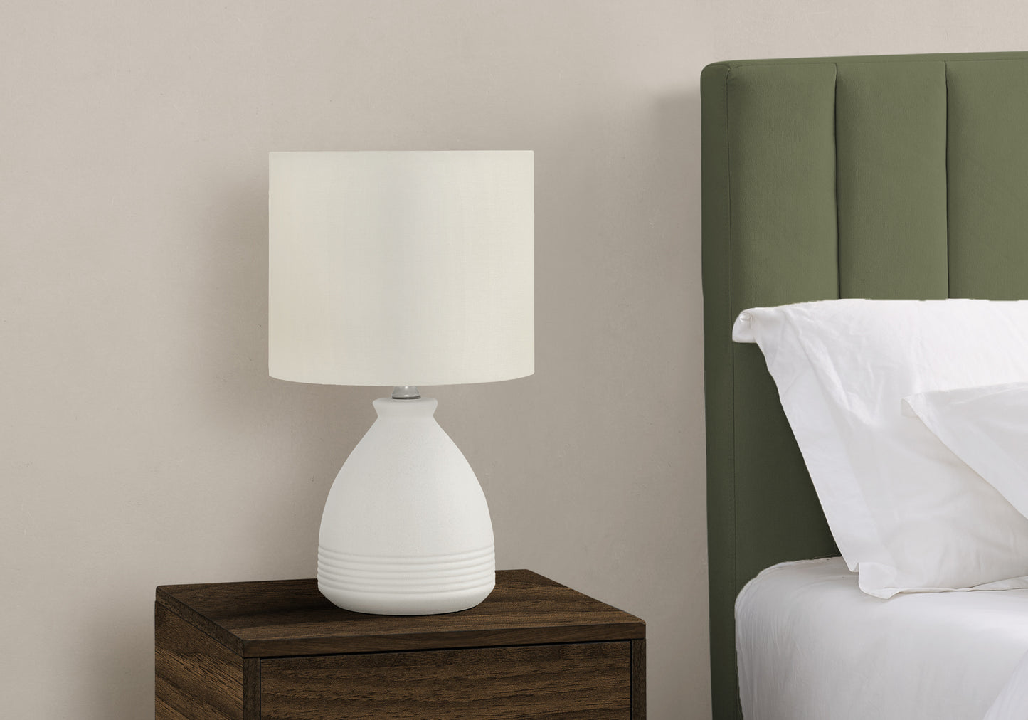 White ceramic bedside lamp with a ribbed base offering ambient lighting for bedrooms
