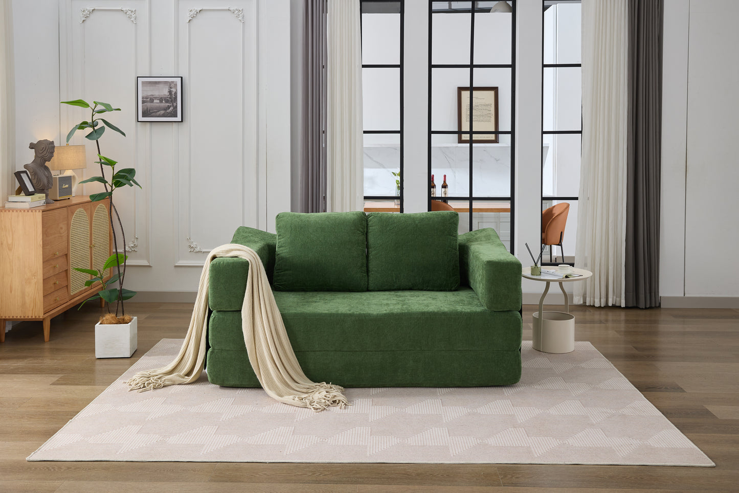 Plush green velvet sofa with cream throw perfect for modern living rooms