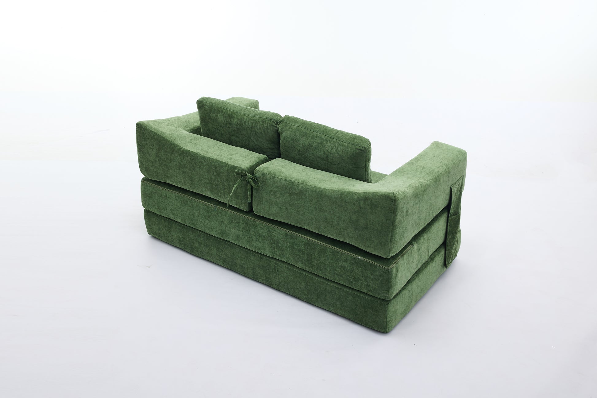 Green velvet modular sofa with stacked cushion design and tie accent