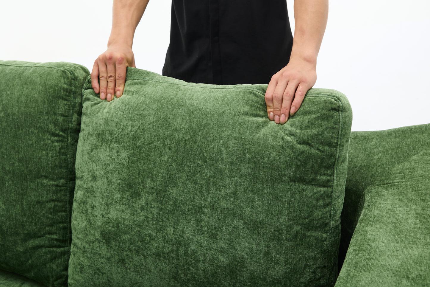 Plush green velvet sofa cushions with tufted detailing and stitched seams perfect for a cozy living room