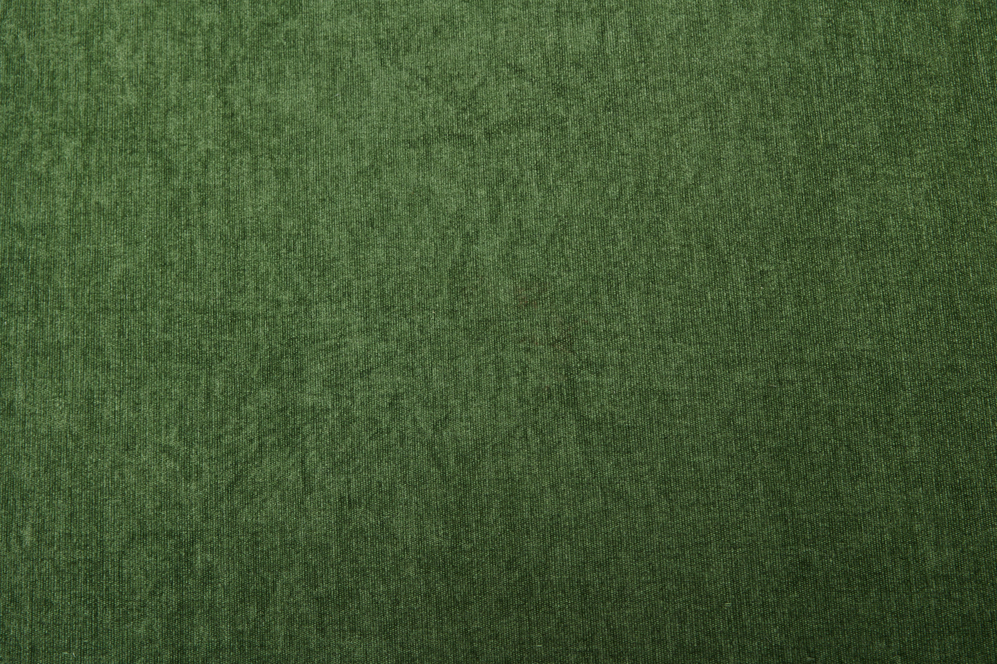 Dark green velvet fabric texture closeup for upholstery