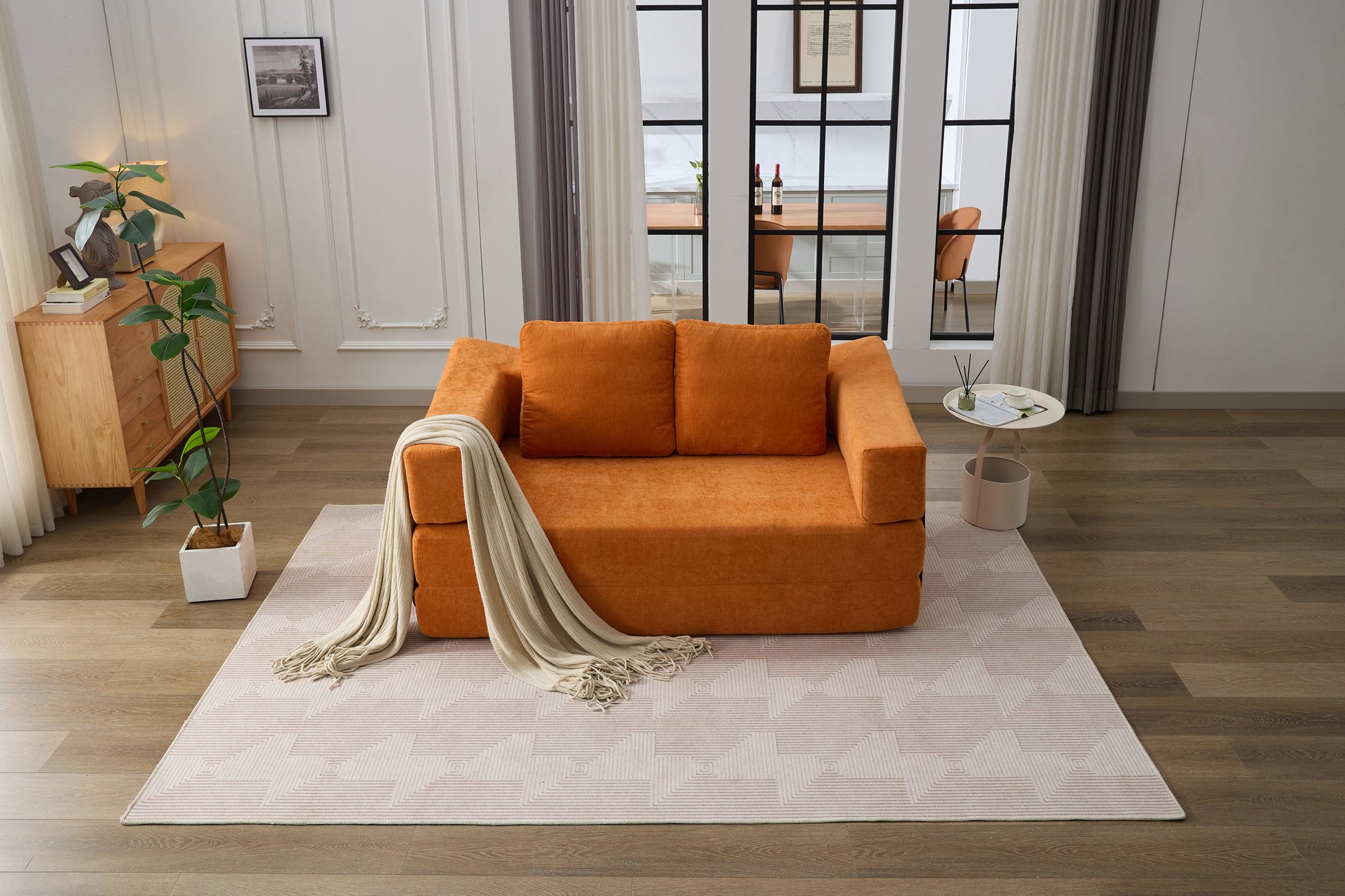 Compact orange sofa bed with plush cushions perfect for small living spaces